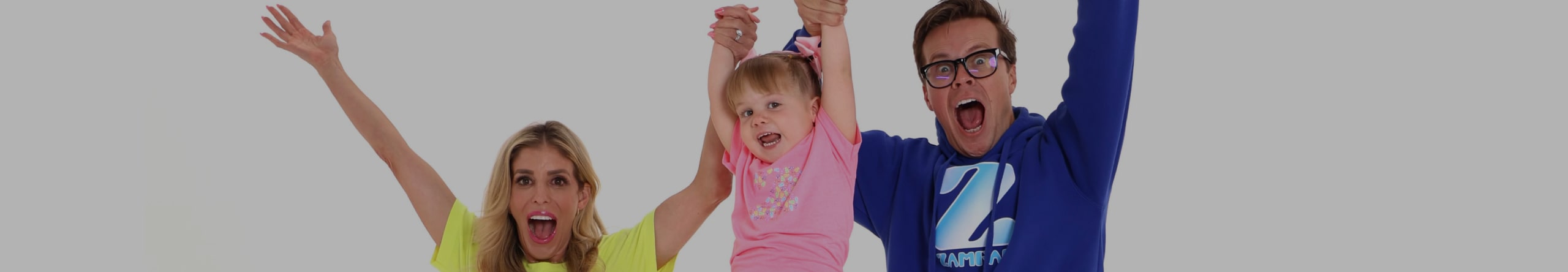 Matt Slays and Rebecca Zamolo holding Zadie Zamolo in the air.