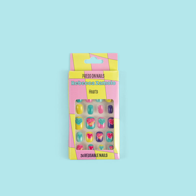Box of press on nails with heart designs.