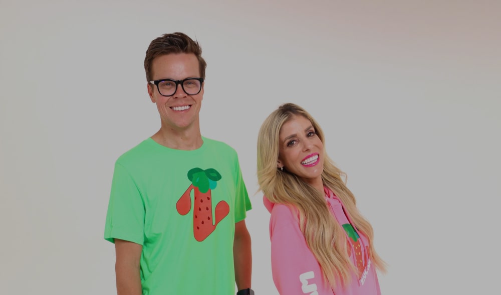 Matt Slays and Rebecca Zamolo smiling while wearing Zamfam merch.