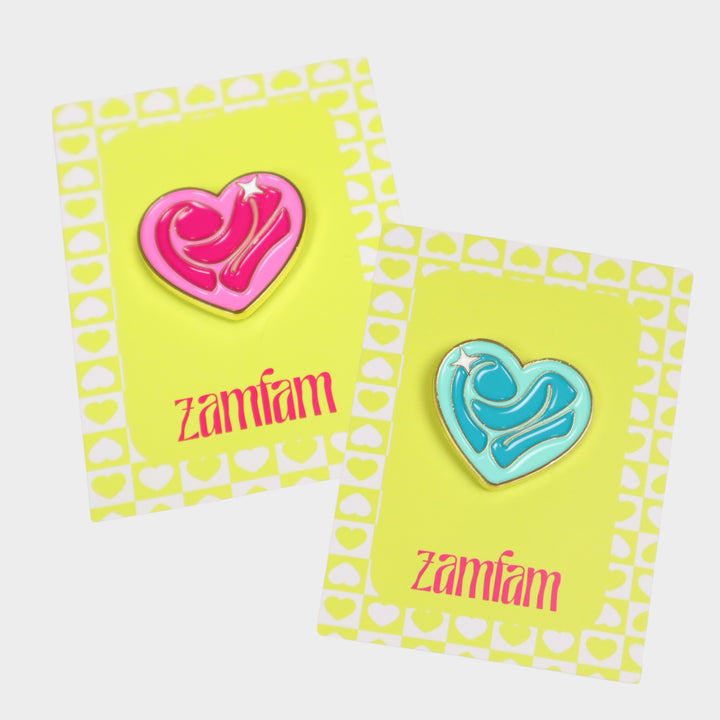 pink and teal RZ Heart enamel pins