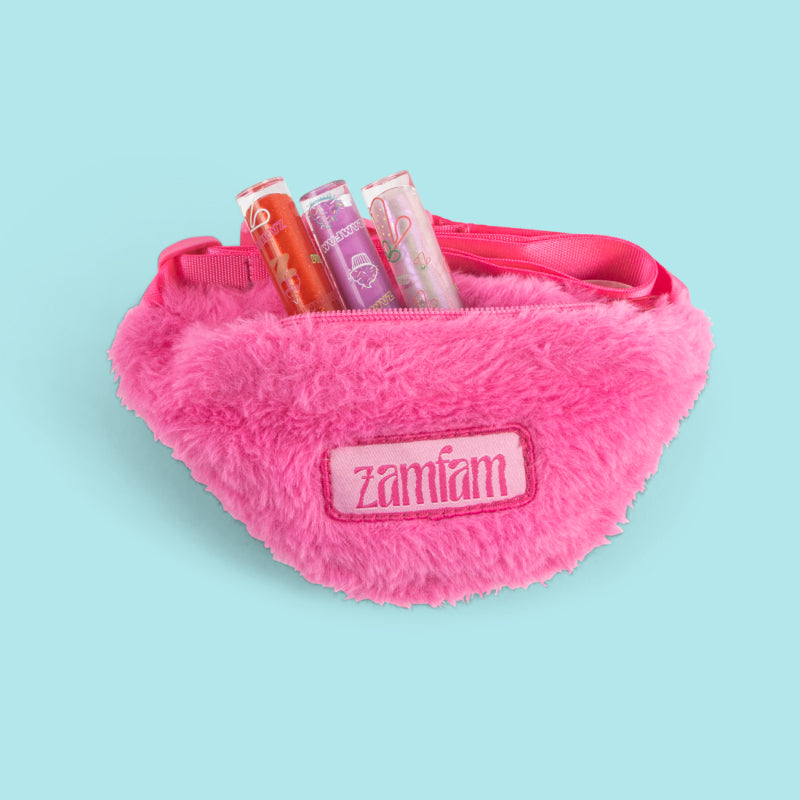 Zamfam pink fuzzy fanny pack with lip glosses sticking out.