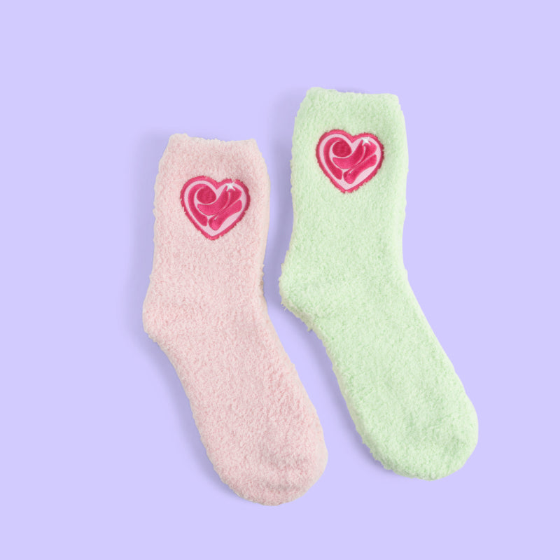 Two pairs of fuzzy Rebecca Zamolo socks in teal and pink.