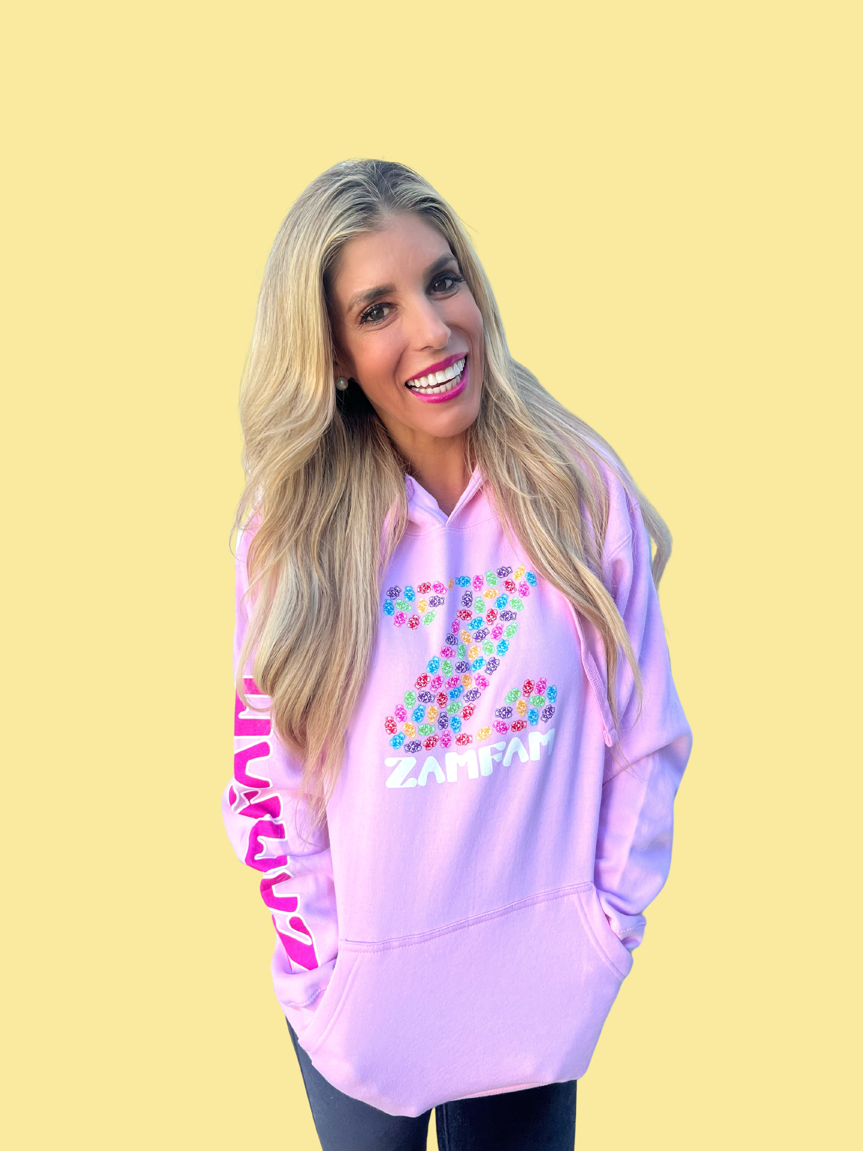 Rebecca Zamolo wearing the pink Zamfam hoodie with gummy bear designs.