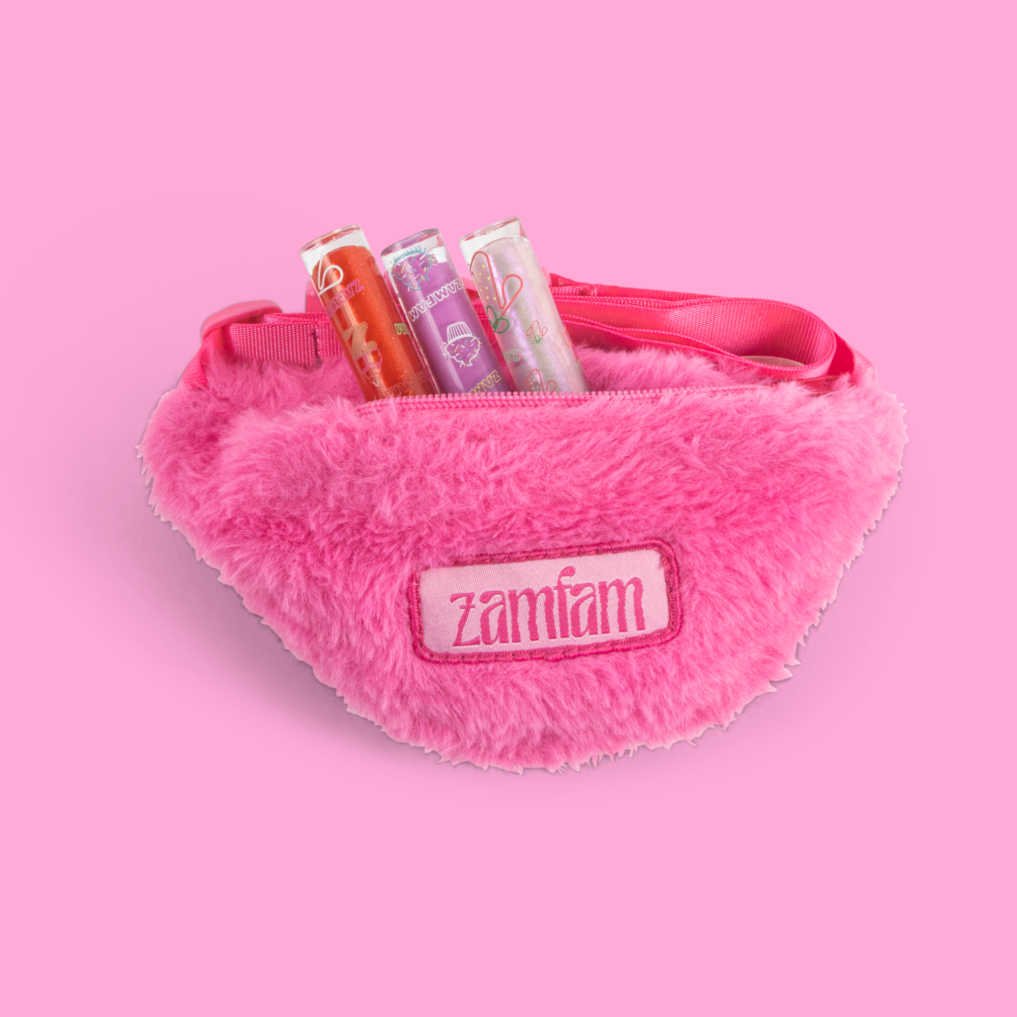 3 lip glosses in the pink fuzzy Zamfam bag.